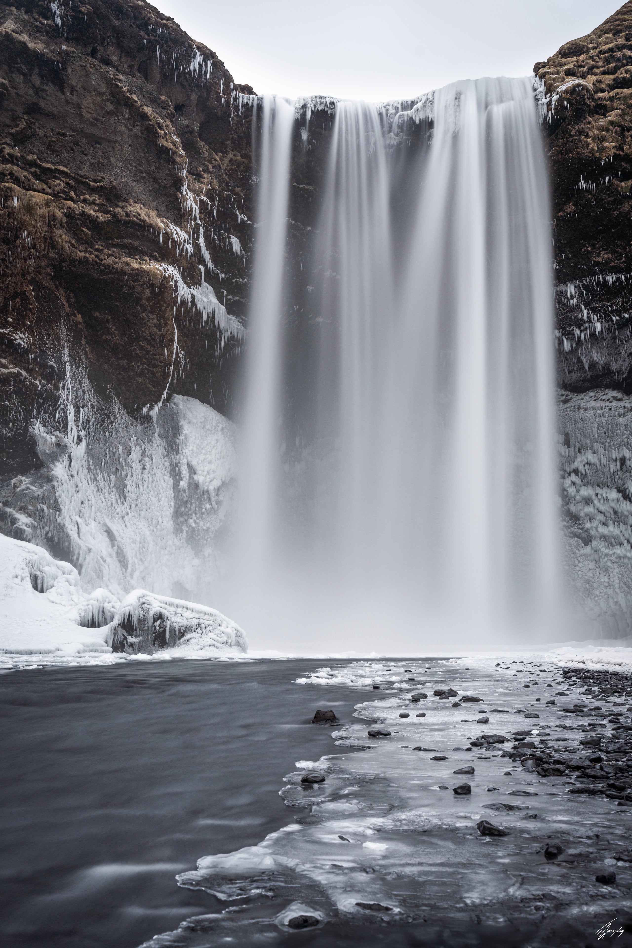 Skogafoss waterfall in Iceland long exposure wall decor print soft flowing water with blue and brown tones in minimalist composition