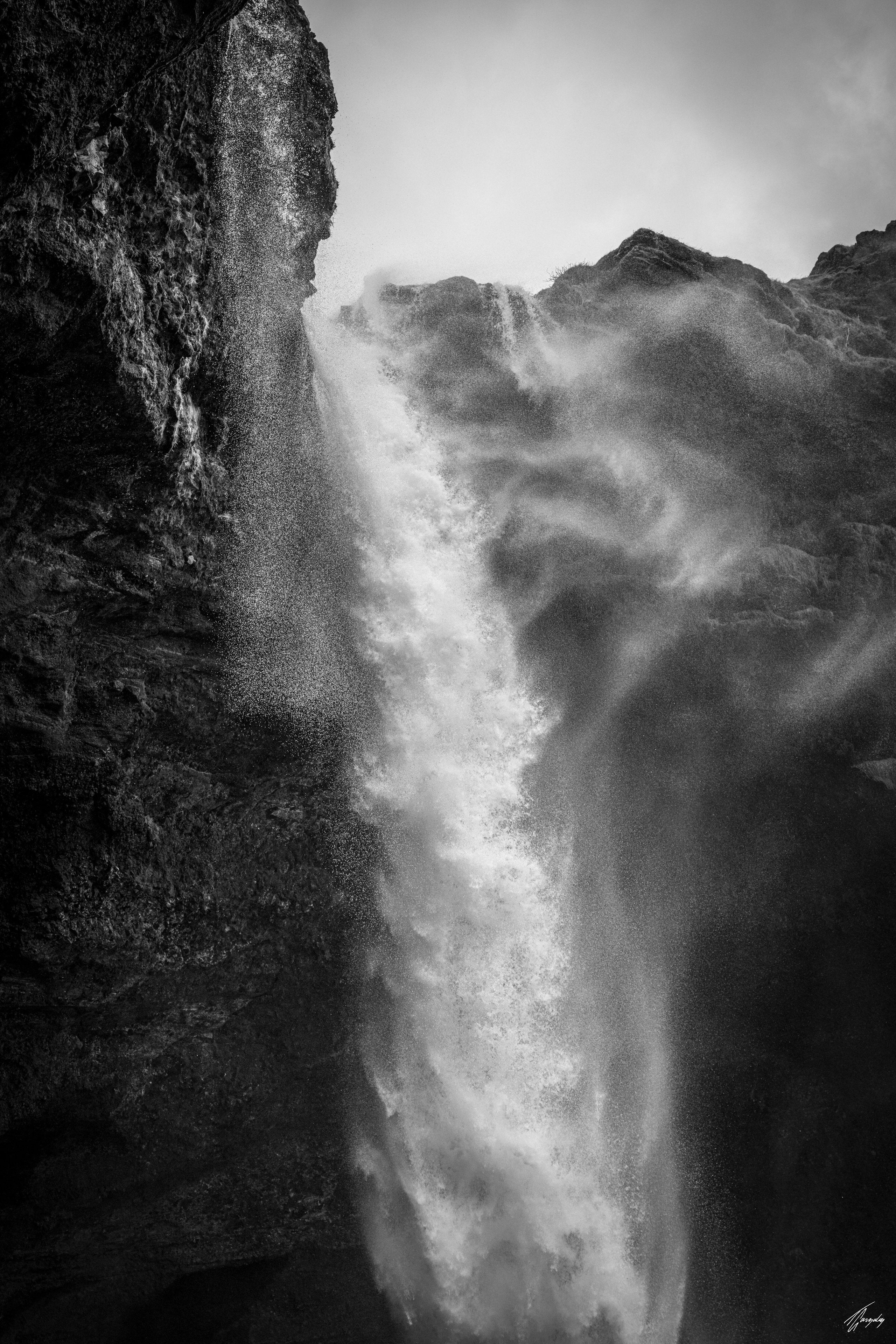 Iceland waterfall in vertical flow fine art photography print powerful falling water with strong contrast and minimalist composition